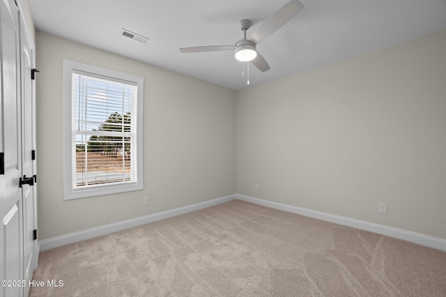 unfurnished room with light carpet, ceiling fan, visible vents, and baseboards