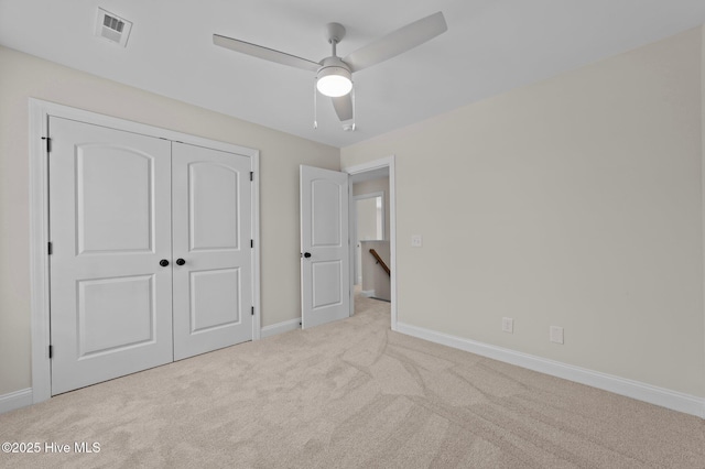 unfurnished bedroom featuring baseboards, a closet, visible vents, and carpet flooring