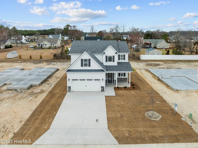 view of front of home with roof with shingles, a porch, concrete driveway, an attached garage, and board and batten siding