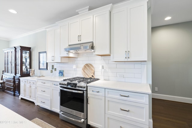 kitchen featuring white cabinets, decorative backsplash, stainless steel gas range oven, and dark wood-type flooring