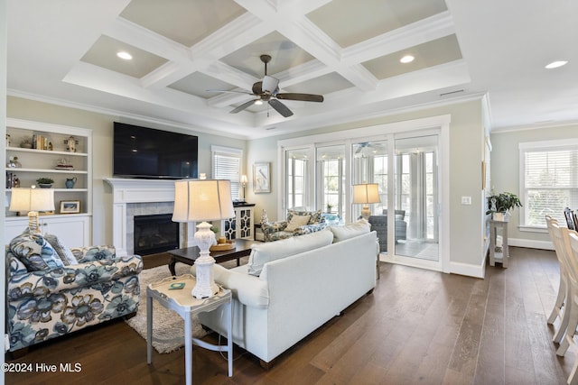 living room with ceiling fan, coffered ceiling, dark hardwood / wood-style floors, a fireplace, and ornamental molding