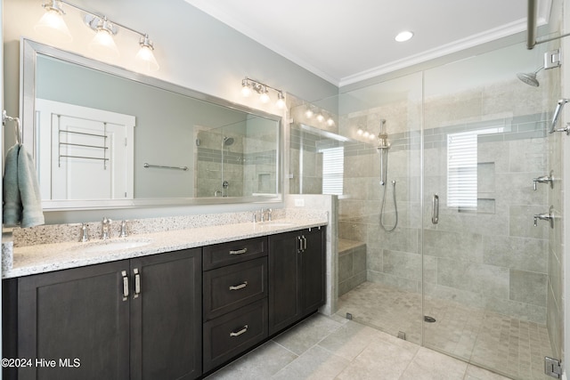 bathroom with vanity, a shower with door, and crown molding