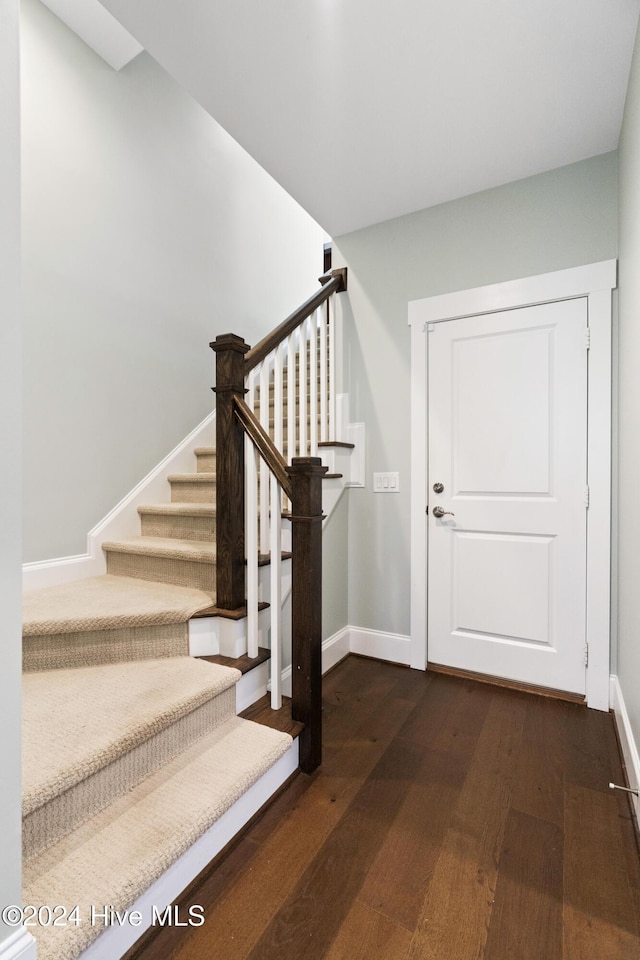 stairs with hardwood / wood-style floors