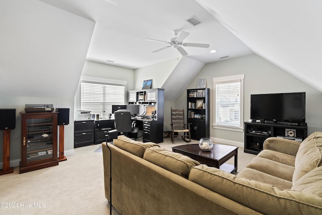 living room with ceiling fan, lofted ceiling, and light carpet