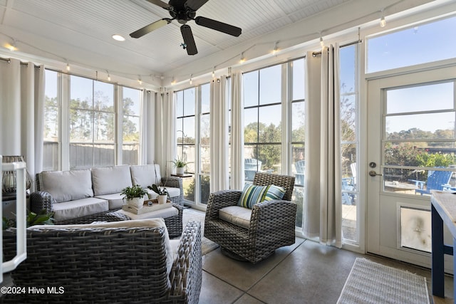 sunroom featuring ceiling fan