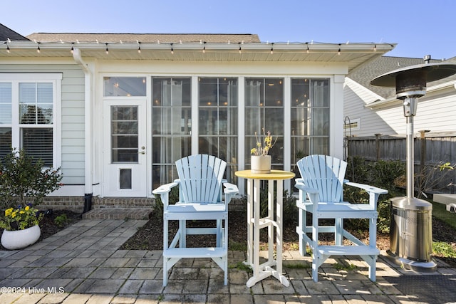 view of patio featuring a sunroom