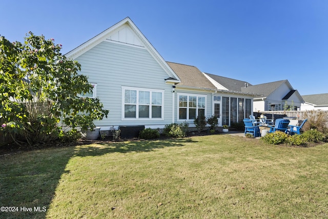 rear view of property featuring a patio area and a lawn