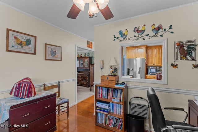 office space featuring crown molding, light wood-type flooring, and ceiling fan