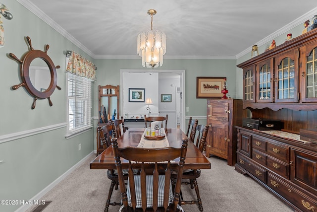 carpeted dining space with ornamental molding and a notable chandelier