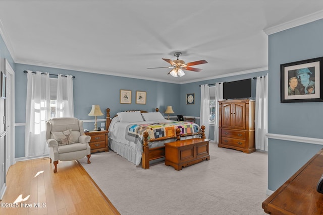 carpeted bedroom with crown molding, ceiling fan, and multiple windows