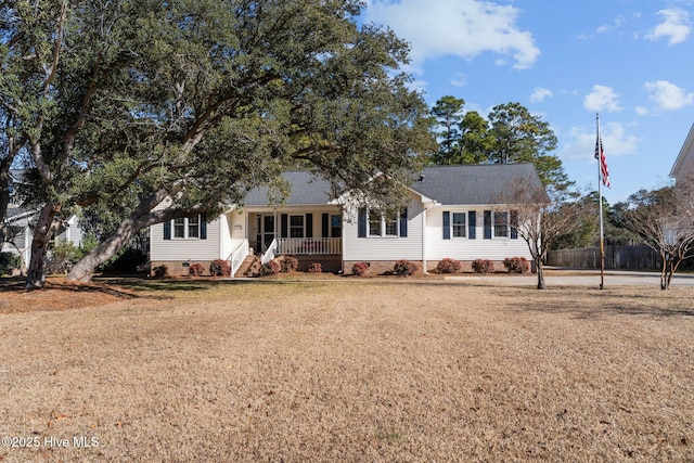 ranch-style home with a front lawn and covered porch