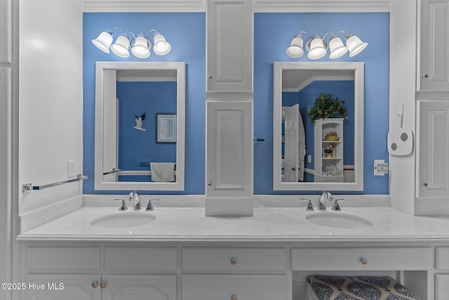 bathroom featuring crown molding and vanity