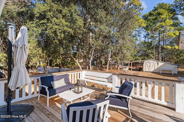 wooden terrace featuring an outdoor living space and a storage shed