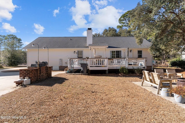 back of property with a wooden deck