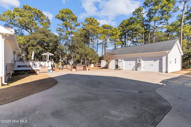 exterior space featuring a garage and an outdoor structure