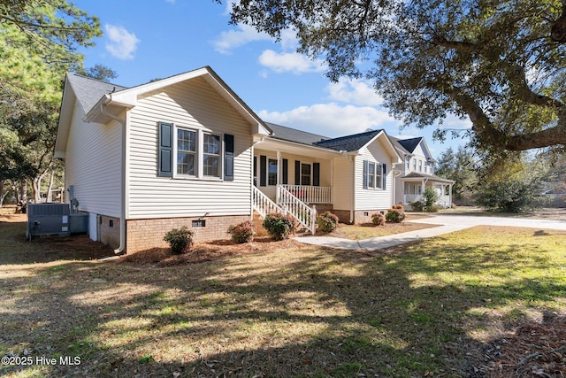 view of front facade featuring central AC, covered porch, and a front lawn