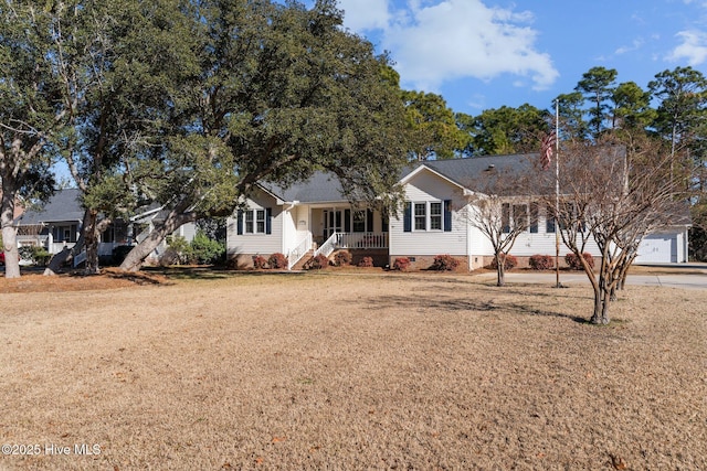 view of front facade with a porch, a garage, and a front lawn