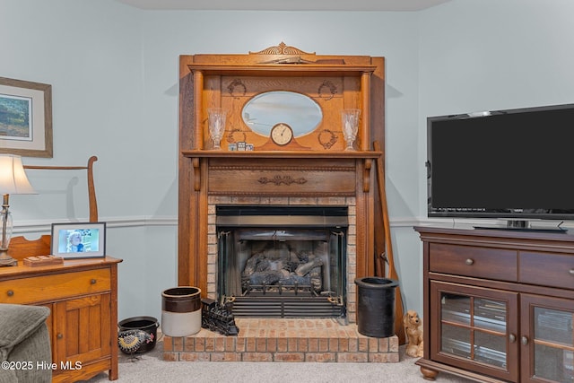 carpeted living room featuring a fireplace