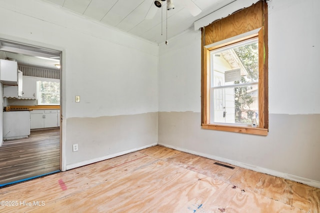 401 Pecan Ln, Lake Waccamaw, NC 28450 - empty room featuring plenty of natural light, wood finished floors, and ceiling fan