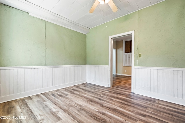 401 Pecan Ln, Lake Waccamaw, NC 28450 - empty room with wood finished floors, ceiling fan, and a textured wall