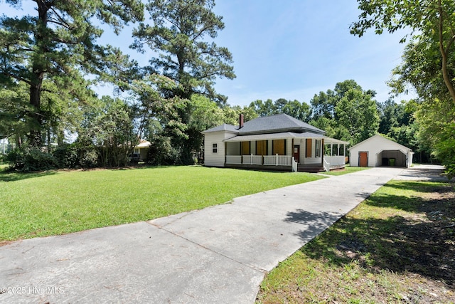 401 Pecan Ln, Lake Waccamaw, NC 28450 - view of front facade with covered porch, a front lawn, an outdoor structure, a garage, and a chimney