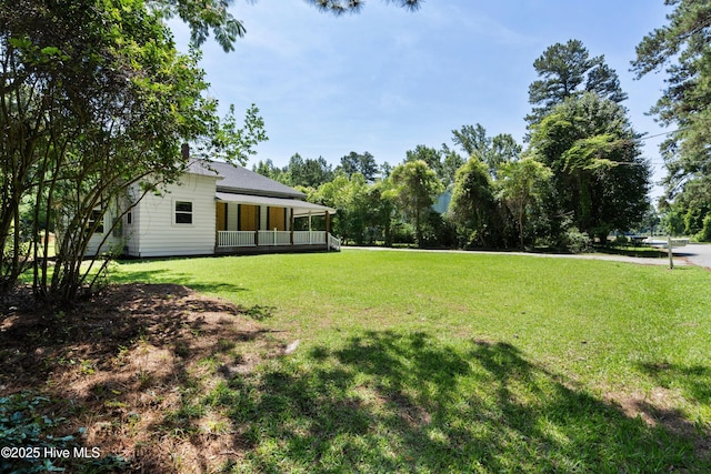 401 Pecan Ln, Lake Waccamaw, NC 28450 - view of grassy yard with covered porch