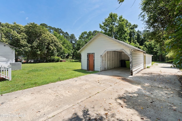 401 Pecan Ln, Lake Waccamaw, NC 28450 - garage featuring concrete driveway and view of scattered trees
