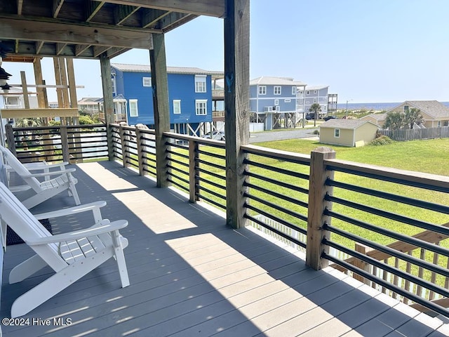 wooden deck featuring a lawn