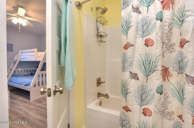 bathroom with hardwood / wood-style floors, shower / bath combo, and ceiling fan