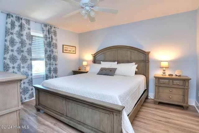 bedroom with light hardwood / wood-style flooring and ceiling fan