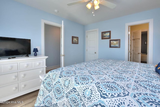 bedroom with hardwood / wood-style floors and ceiling fan