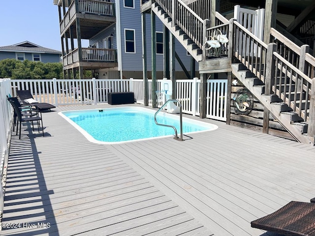 view of swimming pool with a wooden deck