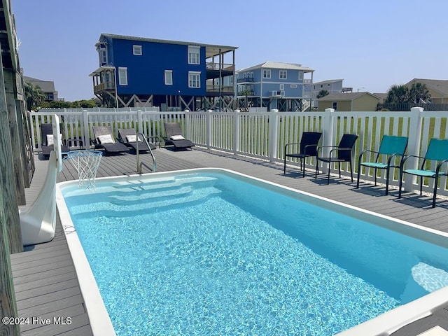 view of swimming pool featuring a deck