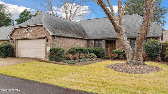 view of front of home with a front yard and a garage