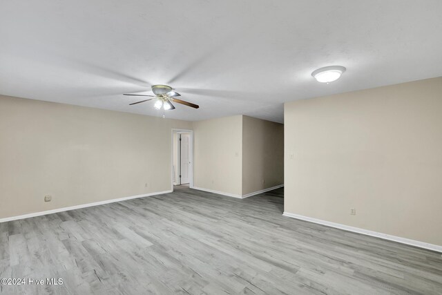 empty room featuring ceiling fan and light wood-type flooring