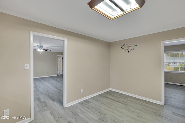 empty room with crown molding, ceiling fan, and light hardwood / wood-style floors