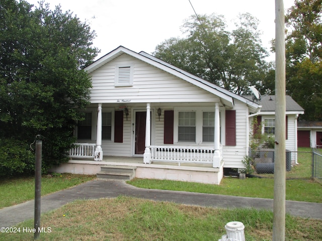 view of front of house with a front lawn and a porch