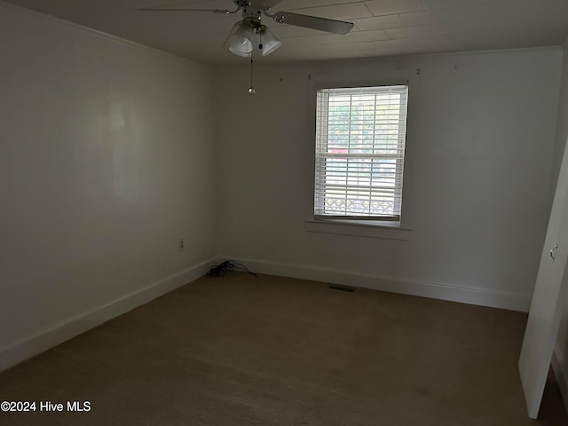 spare room featuring carpet flooring and ceiling fan