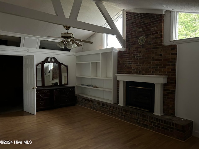 unfurnished living room with a fireplace, hardwood / wood-style floors, vaulted ceiling, and ceiling fan