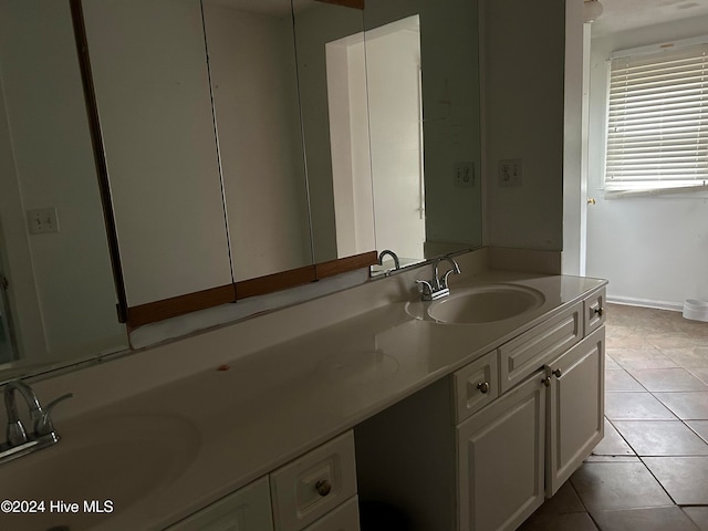 bathroom with tile patterned flooring and vanity