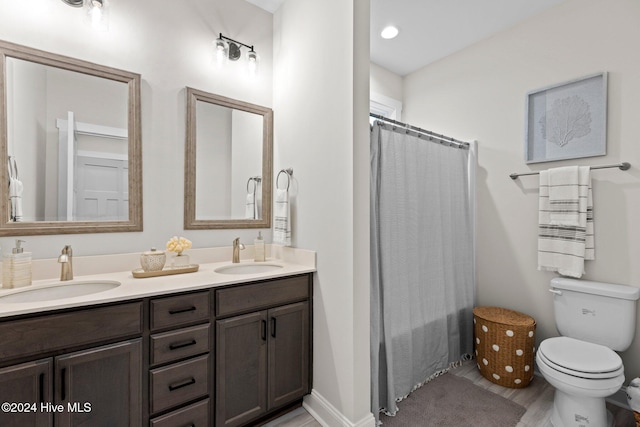 bathroom with a shower with shower curtain, vanity, hardwood / wood-style flooring, and toilet