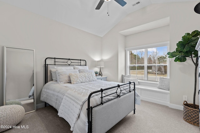 carpeted bedroom with ceiling fan and vaulted ceiling