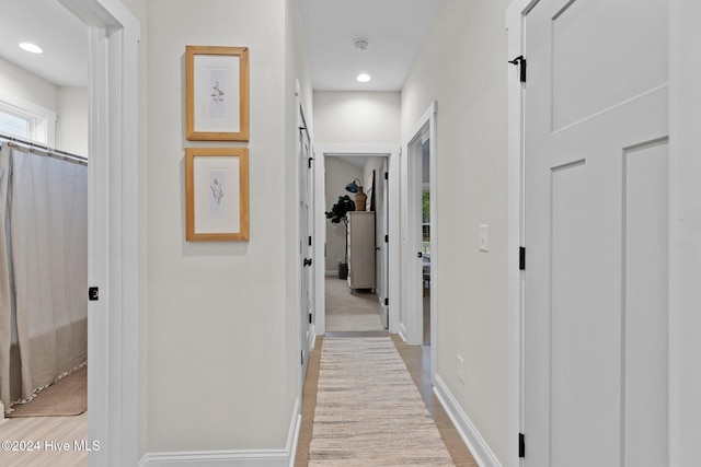 hallway with light hardwood / wood-style flooring