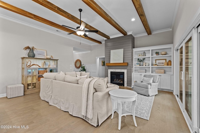 living room with beam ceiling, light hardwood / wood-style floors, ceiling fan, and ornamental molding