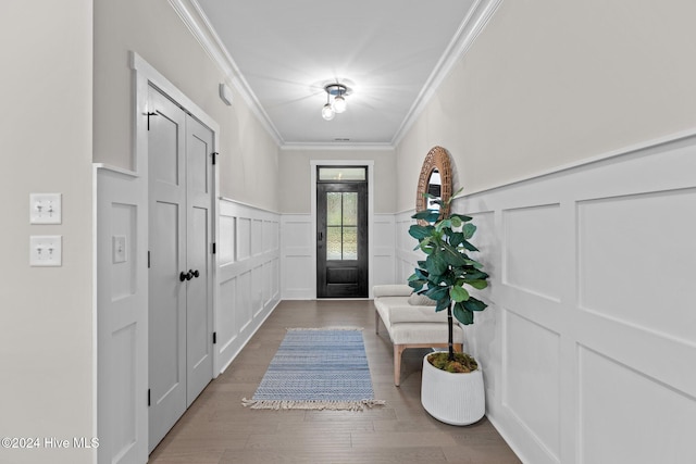 foyer entrance featuring wood-type flooring and crown molding