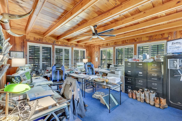 carpeted office space with beam ceiling, wood walls, ceiling fan, and wooden ceiling