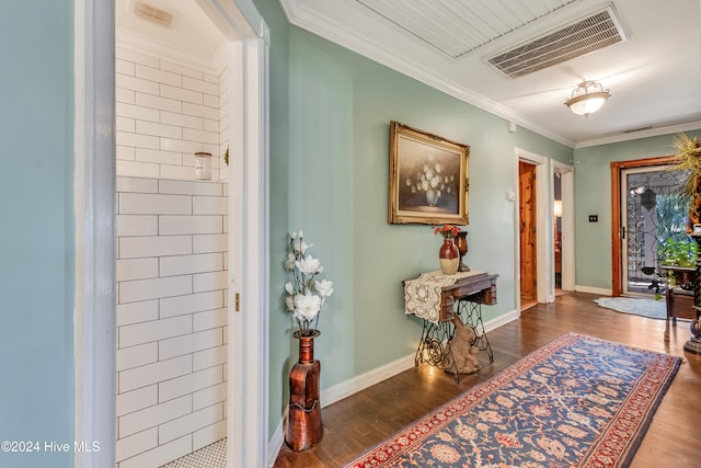 foyer with crown molding and dark hardwood / wood-style floors