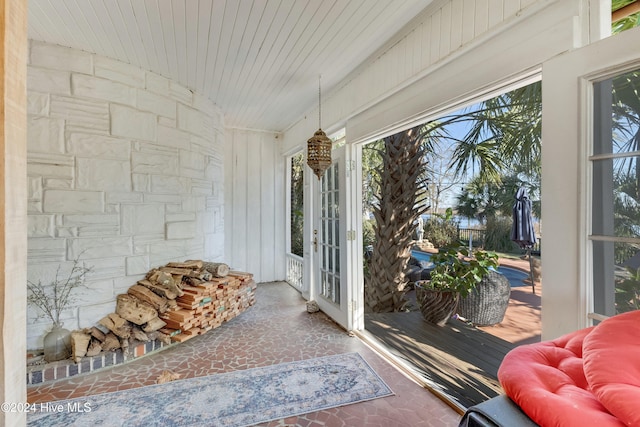 sunroom / solarium featuring wood ceiling