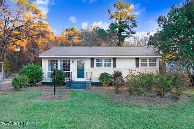 ranch-style home featuring a front yard