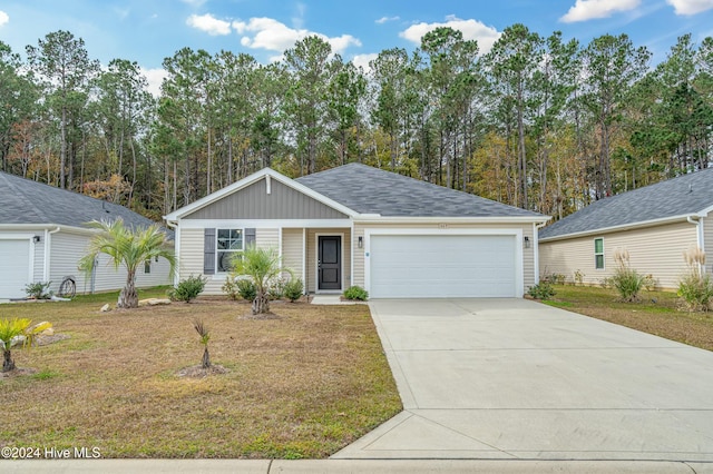 single story home featuring a garage and a front yard